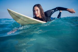 woman-in-wetsuit-with-a-surfboard-481684654_5760x3840-min